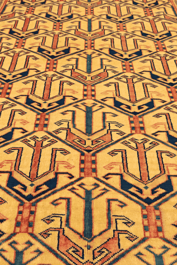 Border detail of gold and navy Caucasian hand-knotted Afghan rug