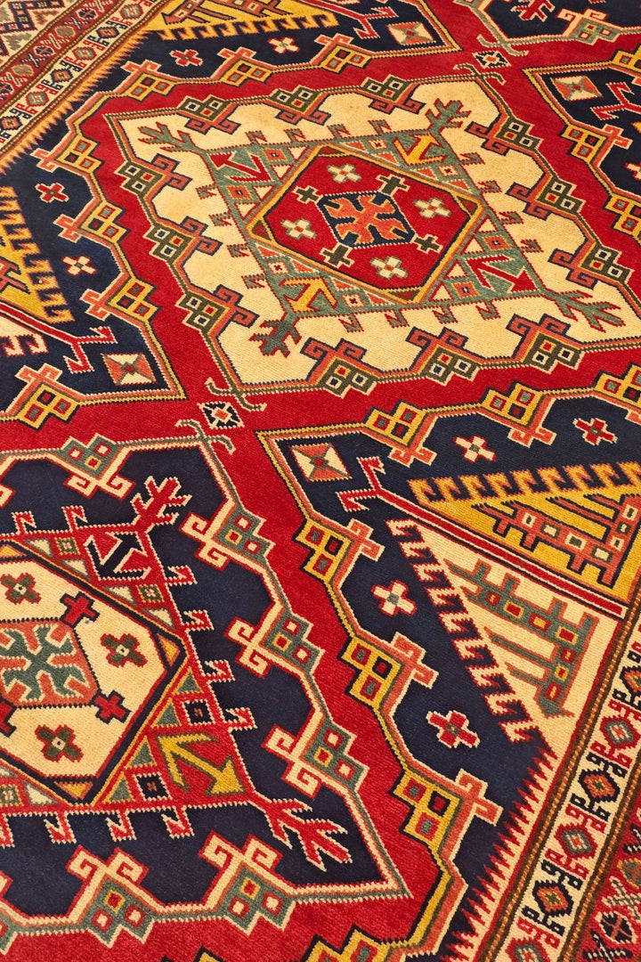 Shirvan medallion detail in navy and red on Afghan Sherwan rug