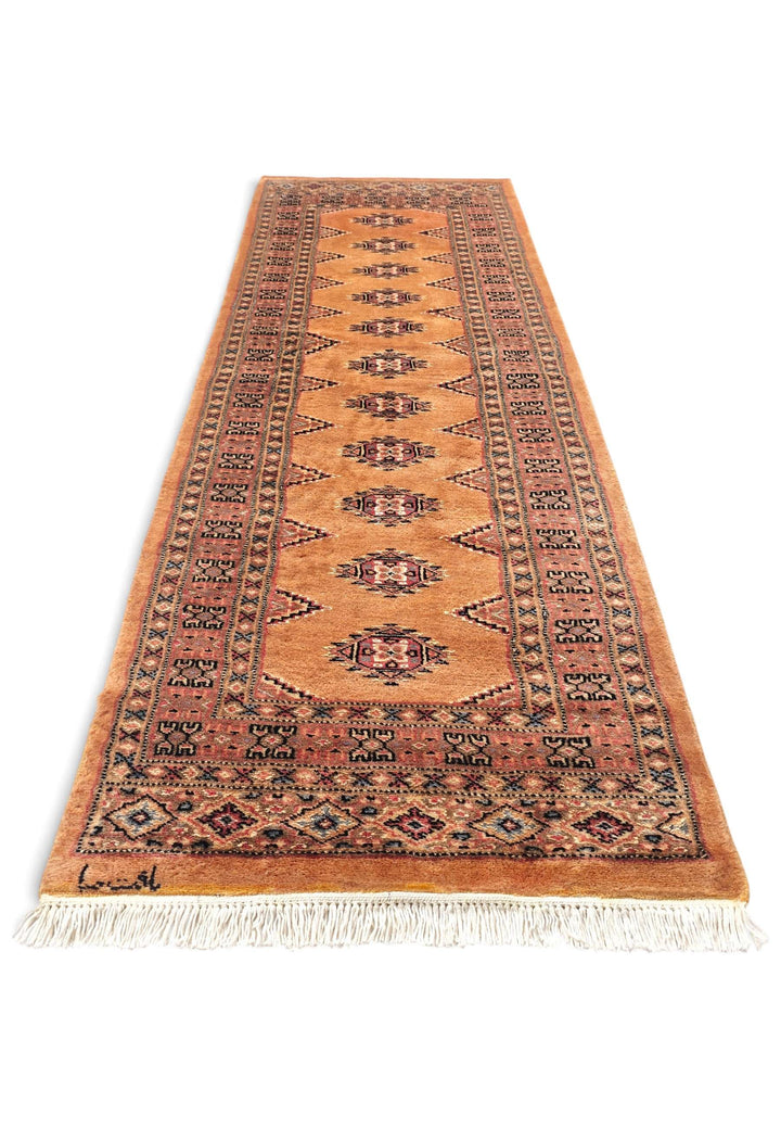 Border detail of apricot Yamoud hand-knotted rug