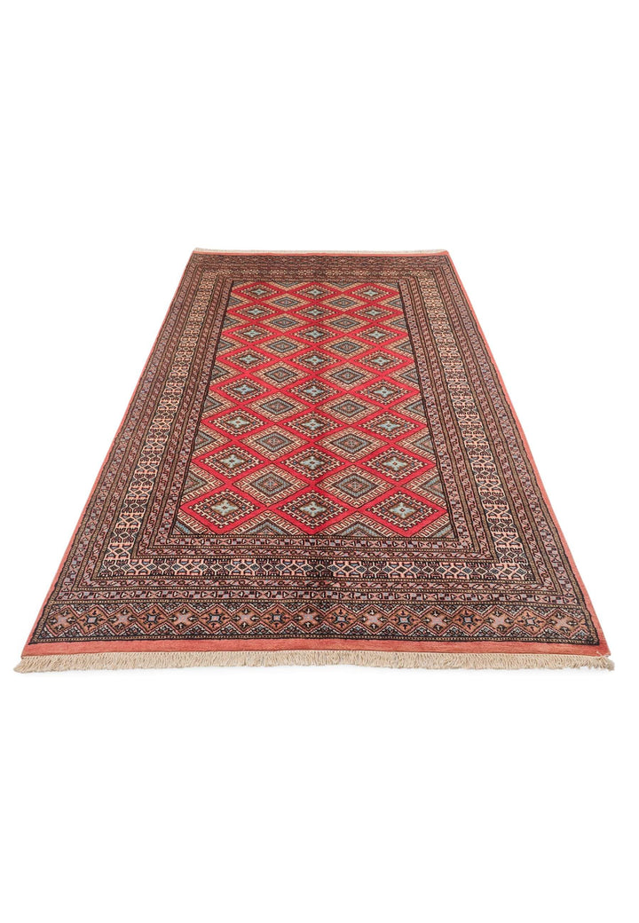 Border detail of crimson lattice hand-knotted Pakistani rug