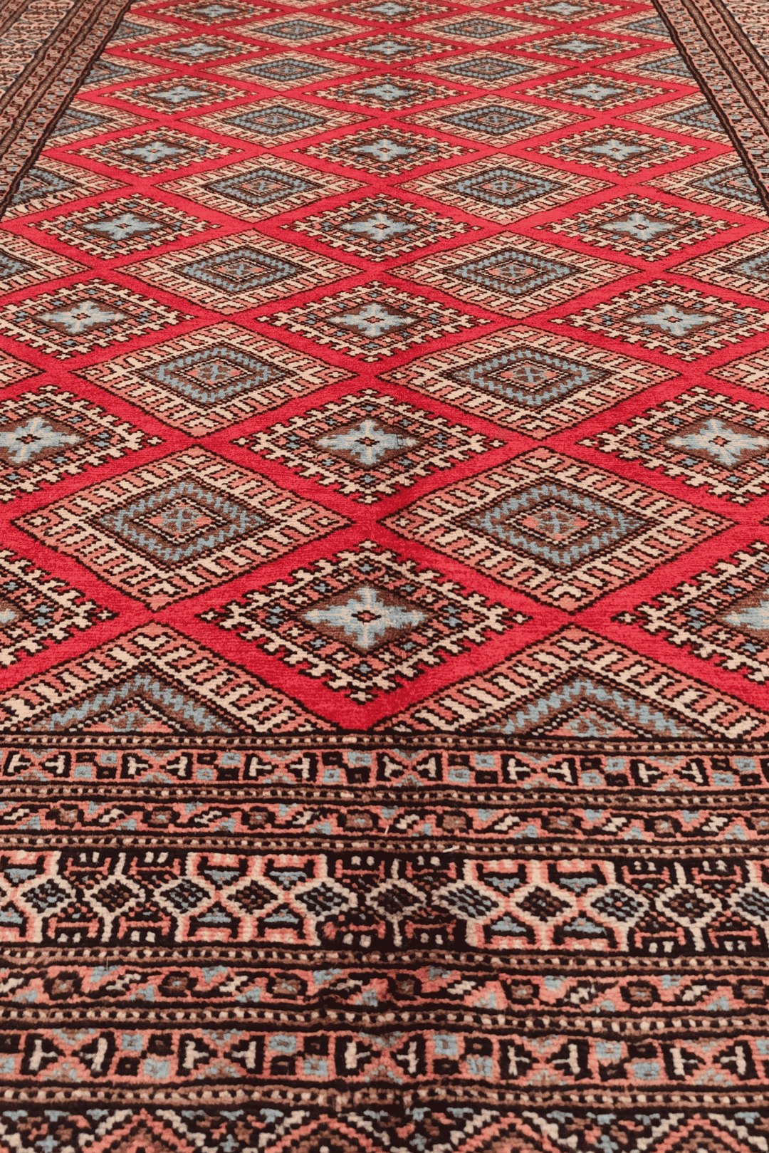 One-of-a-kind crimson and salmon diamond lattice Pakistani rug