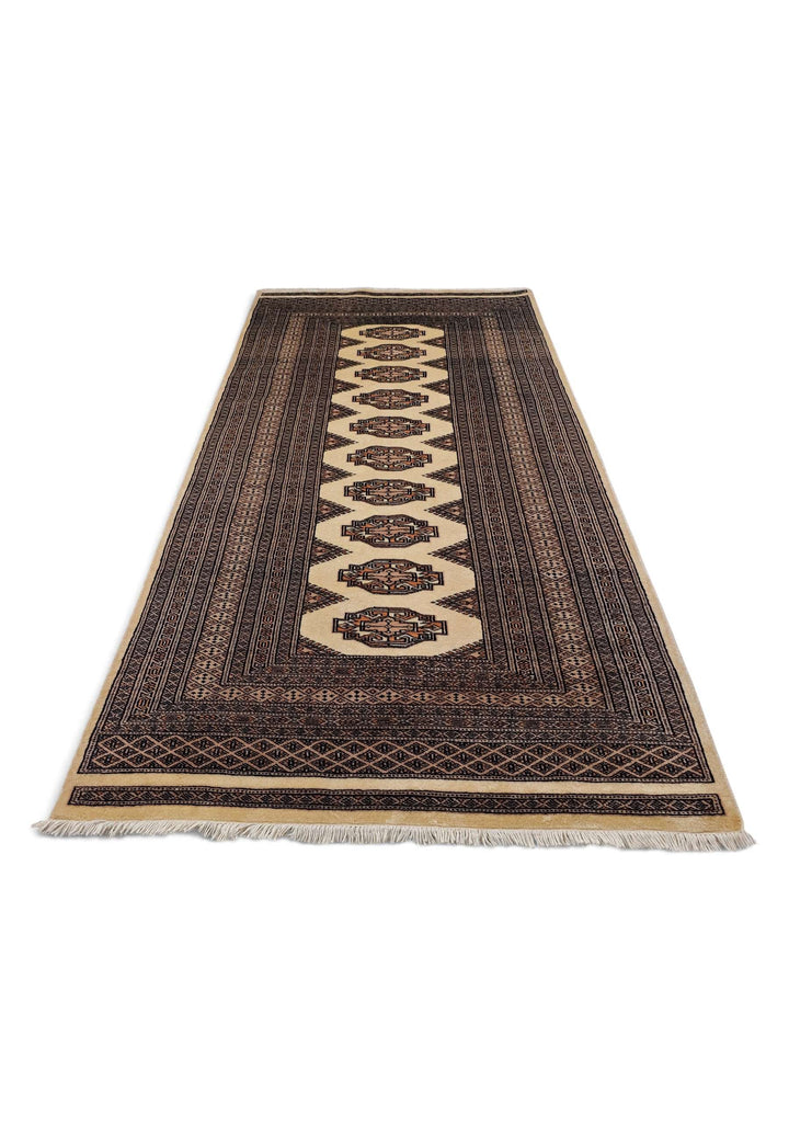Border detail of beige and brown hand-knotted Yamoud rug