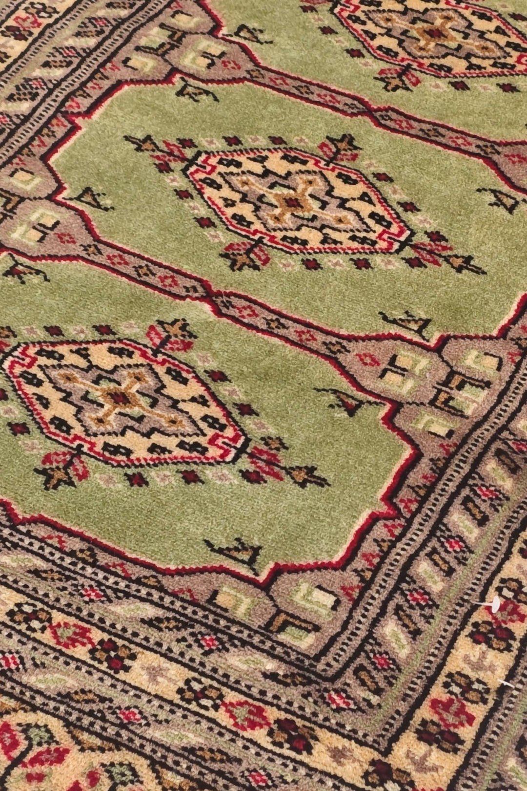 Triple Kazak medallion detail in olive green and gold