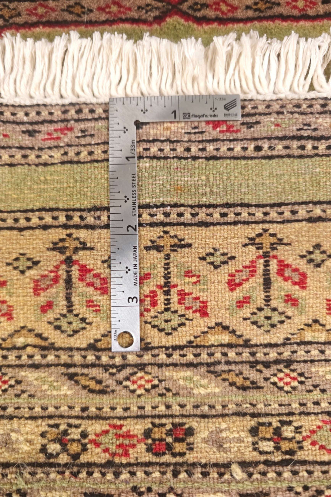 One-of-a-kind olive green and gold Kazak entrance mat