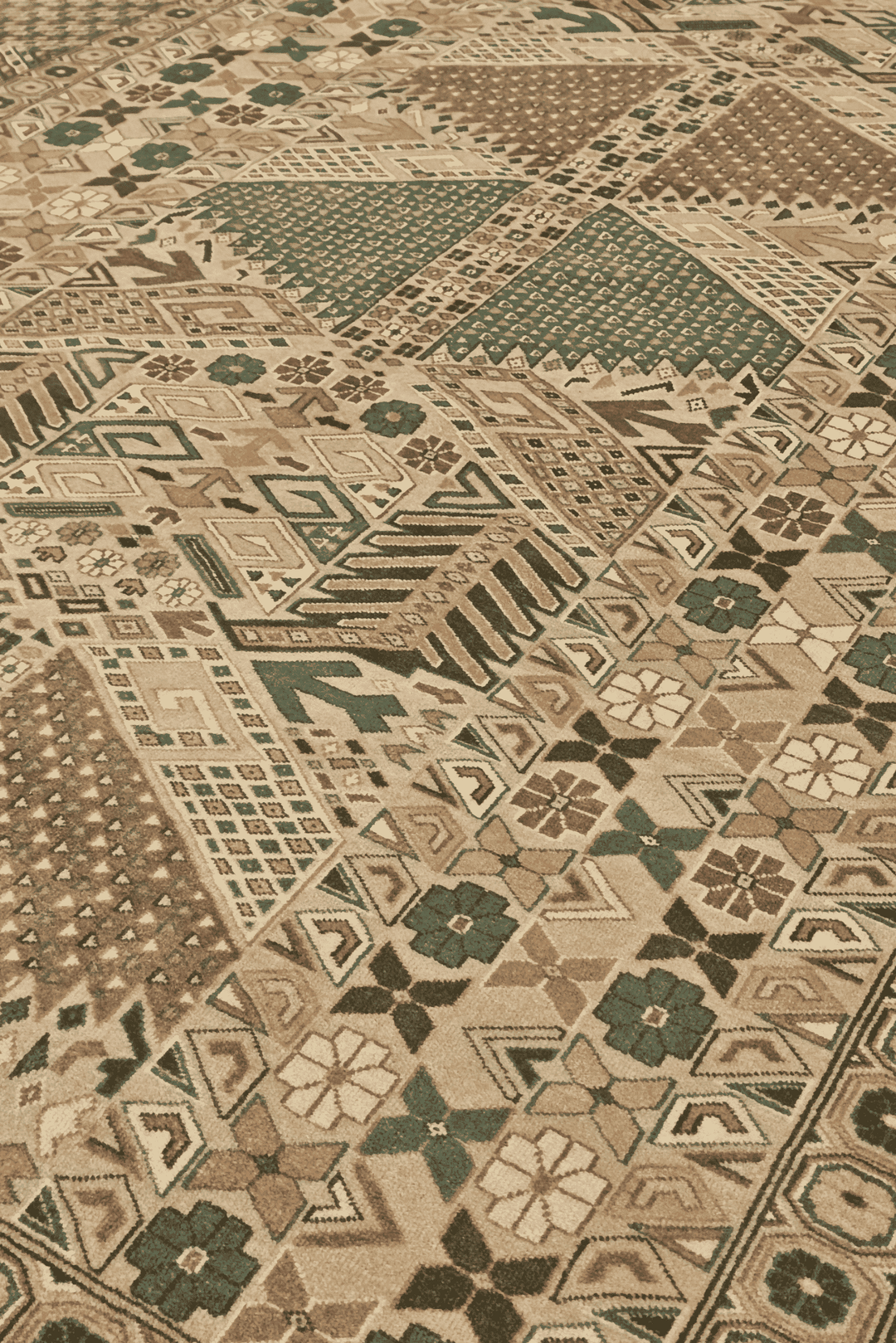 Turkmen gül detail in camel and green on Pakistani rug
