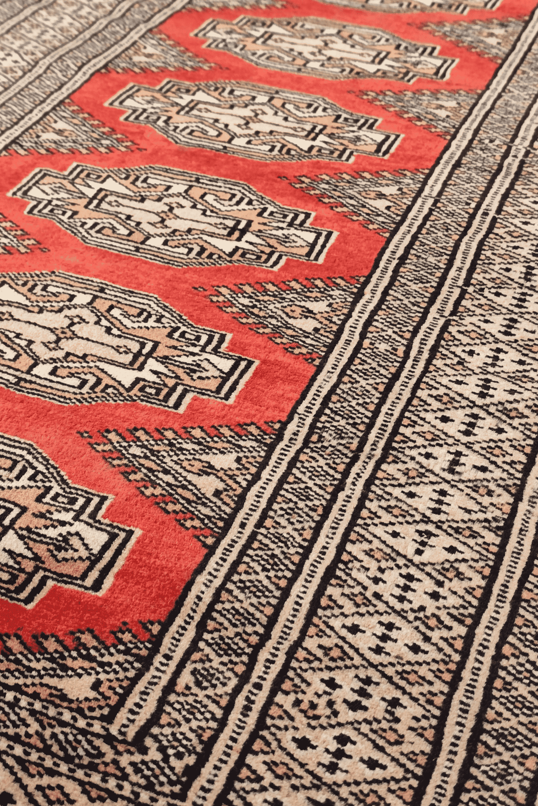 Turkmen Yamoud motifs in red and beige on wool rug