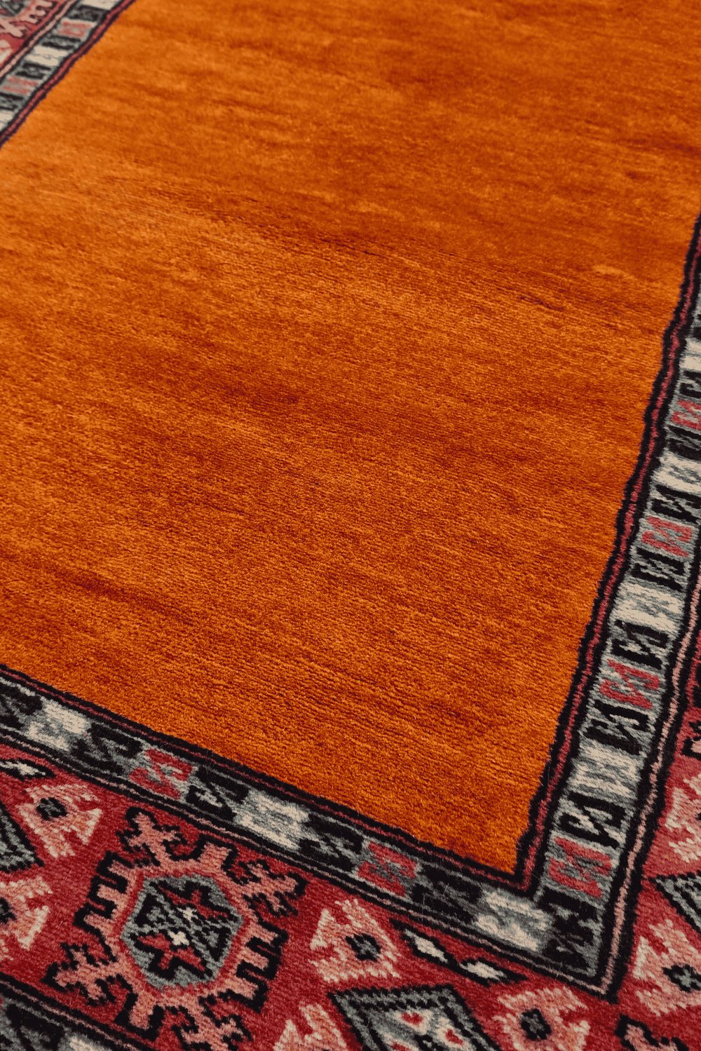 Plain field detail in saffron and rose on Pakistani runner