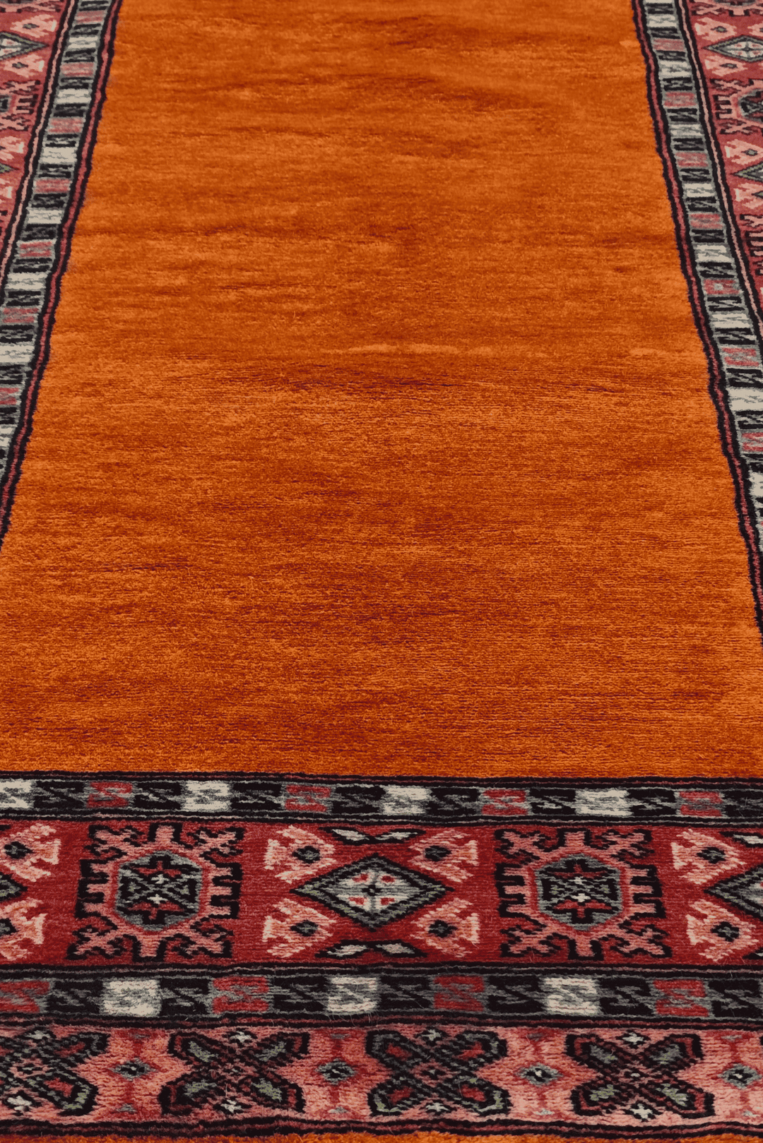 Hand-knotted saffron runner with quiet plain field