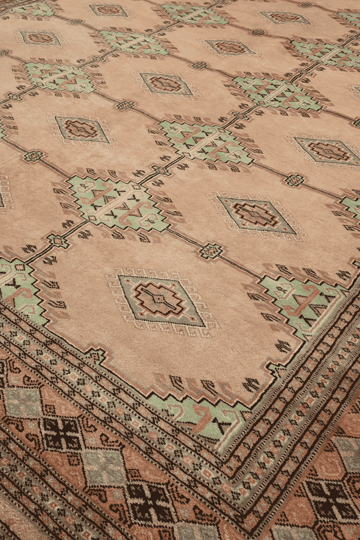 Alternating lattice detail in blush camel and sage on Pakistani rug