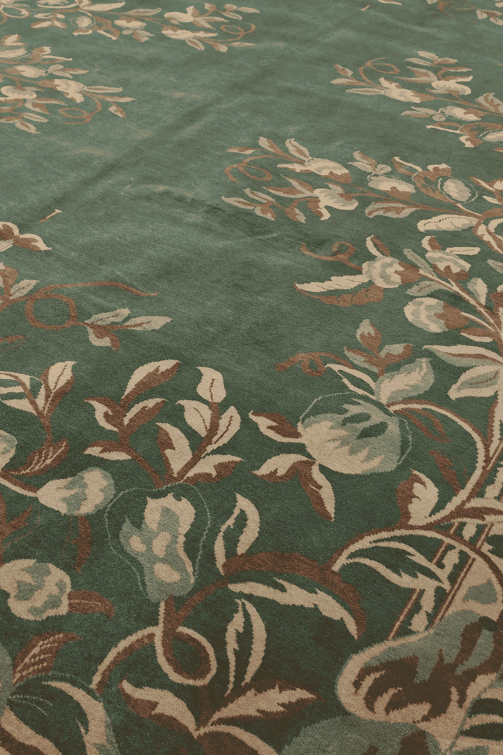 Gol Farang floral detail in green and camel on Pakistani rug
