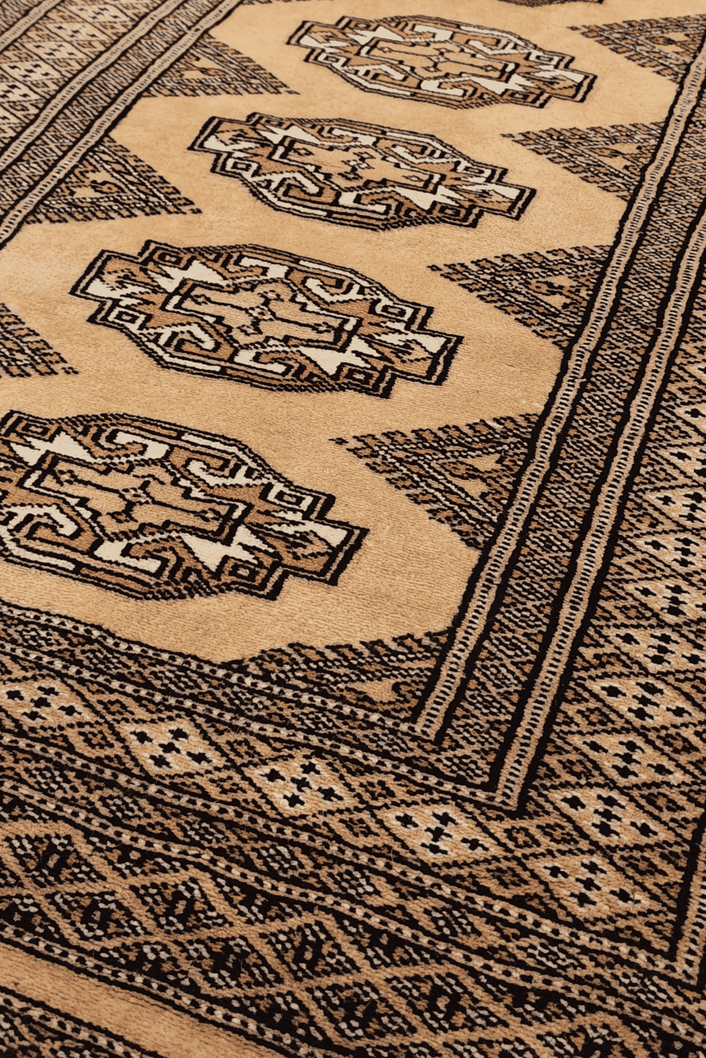 Turkmen Yamoud motifs in wheat gold and beige on wool rug