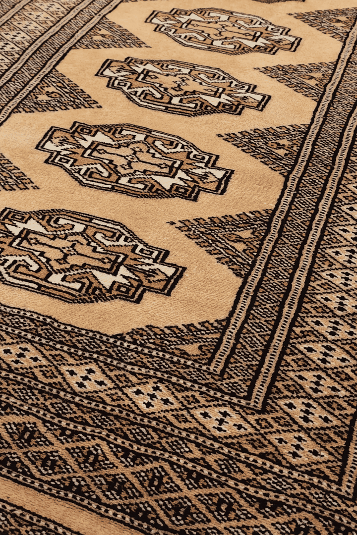 Turkmen Yamoud motifs in wheat gold and beige on wool rug