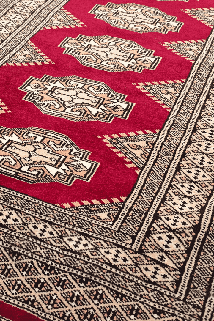 Turkmen Yamoud motifs in wine red and beige on wool rug