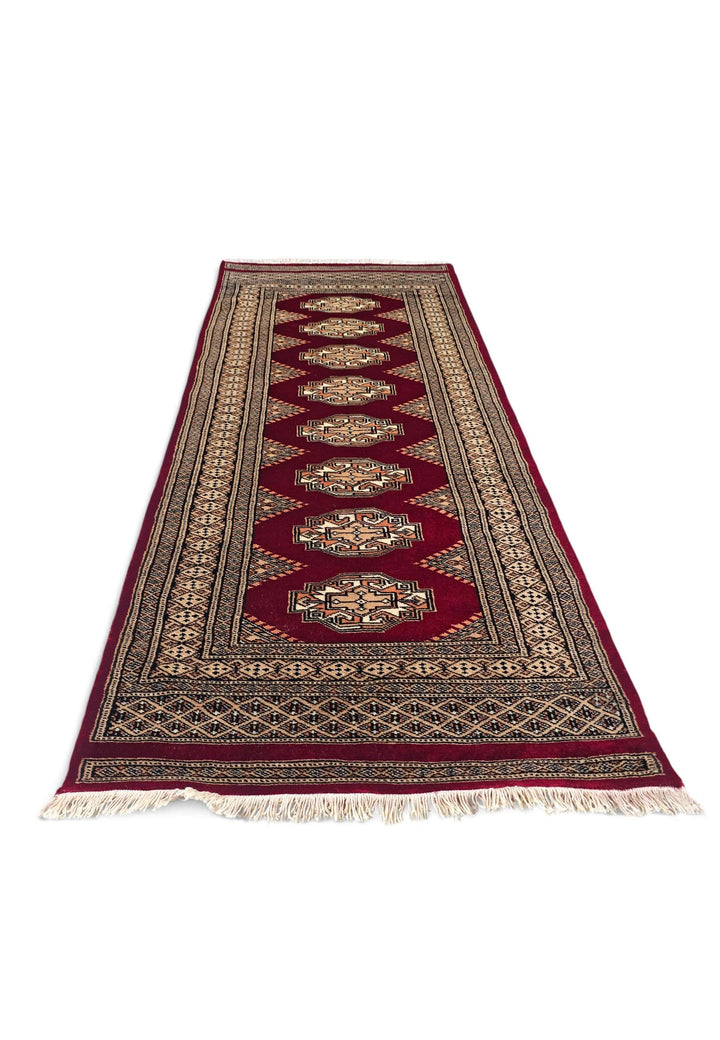 Border detail of wine red and beige hand-knotted Yamoud rug