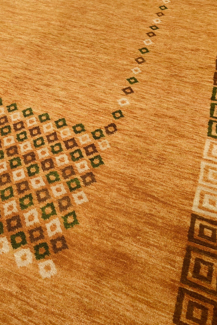 Diamond frame detail in amber and brown on Loribaf rug