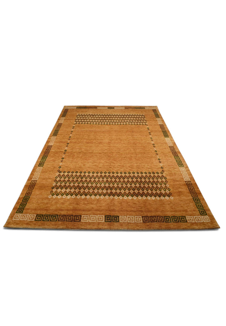 Border detail of amber Loribaf hand-knotted rug