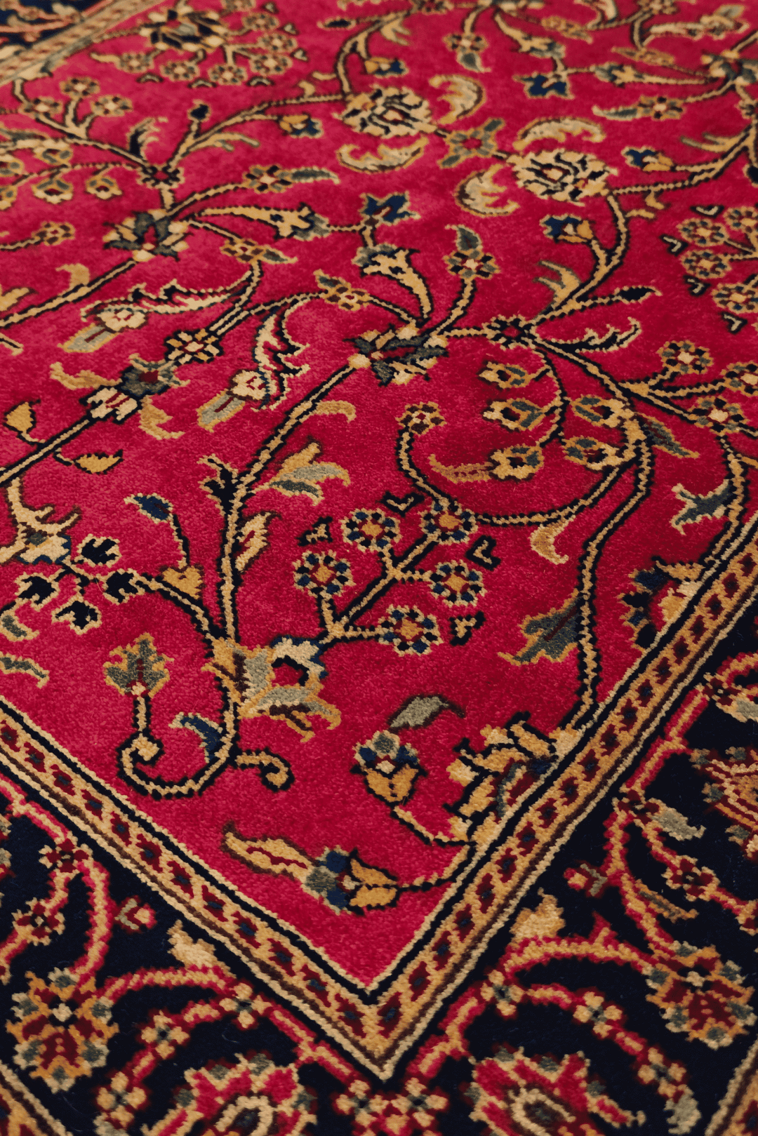 Sarouk floral detail in crimson and indigo on Indian rug