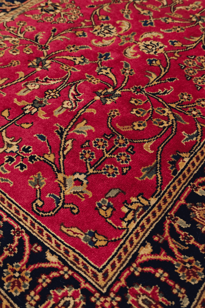 Sarouk floral detail in crimson and indigo on Indian rug