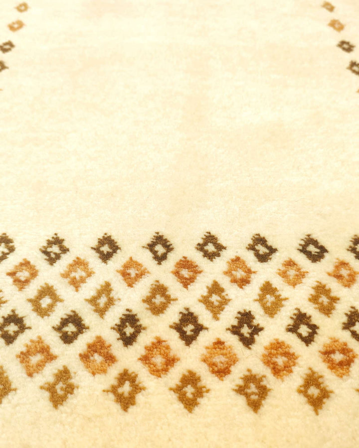 Border detail of ivory Loribaf hand-knotted rug