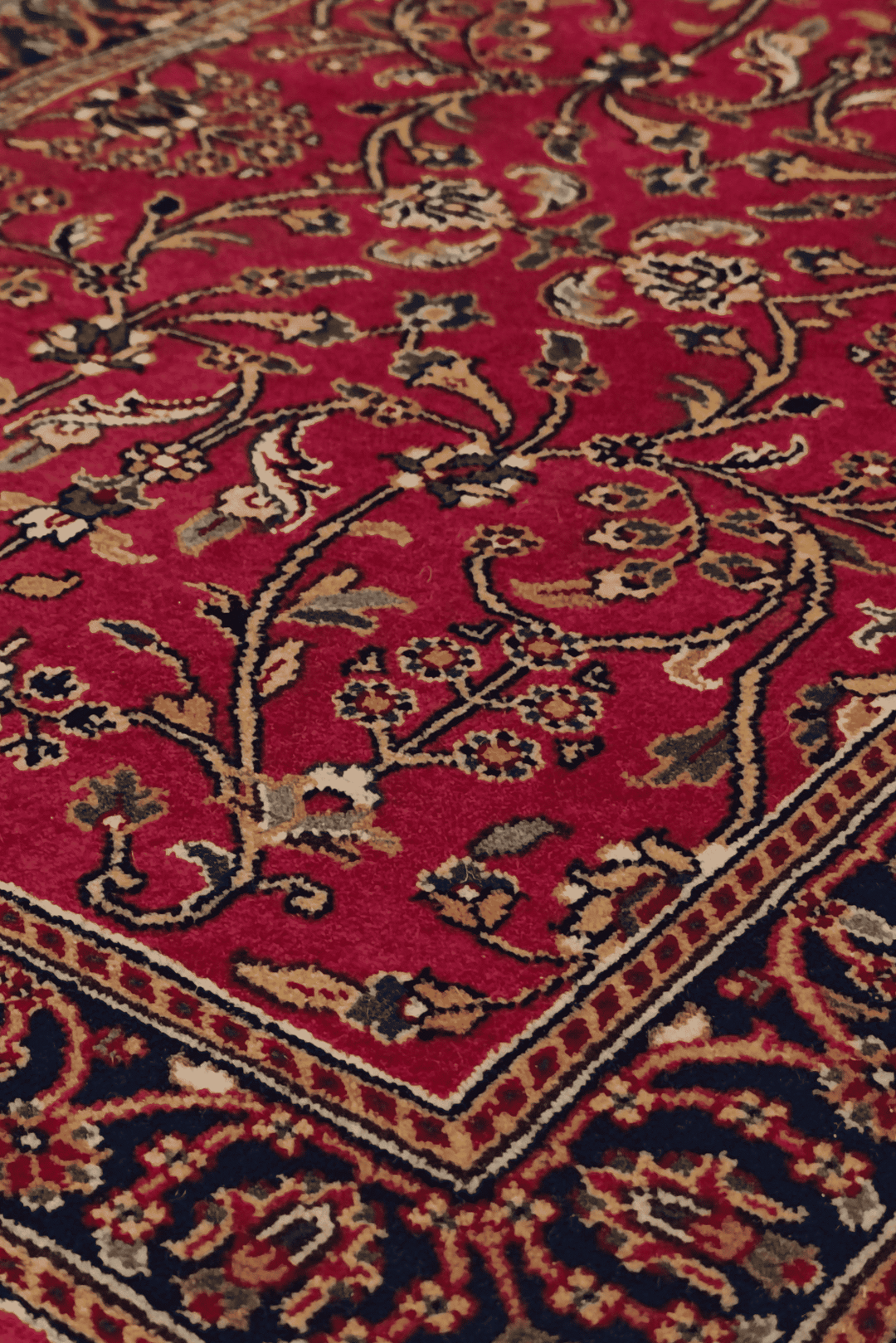 Hereke floral detail in oxblood and navy on Indian rug