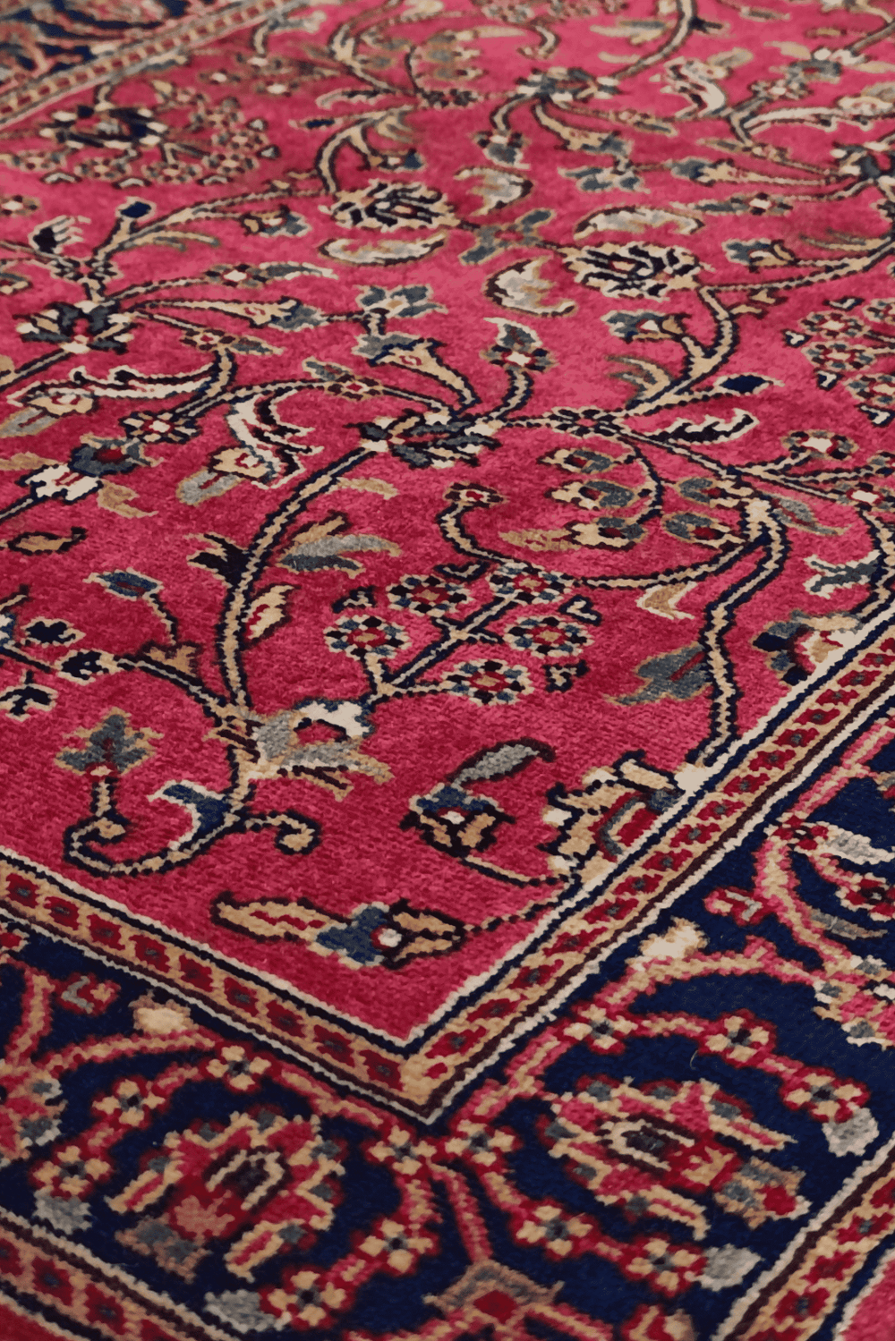 Hereke floral vine detail in magenta and navy on Indian rug