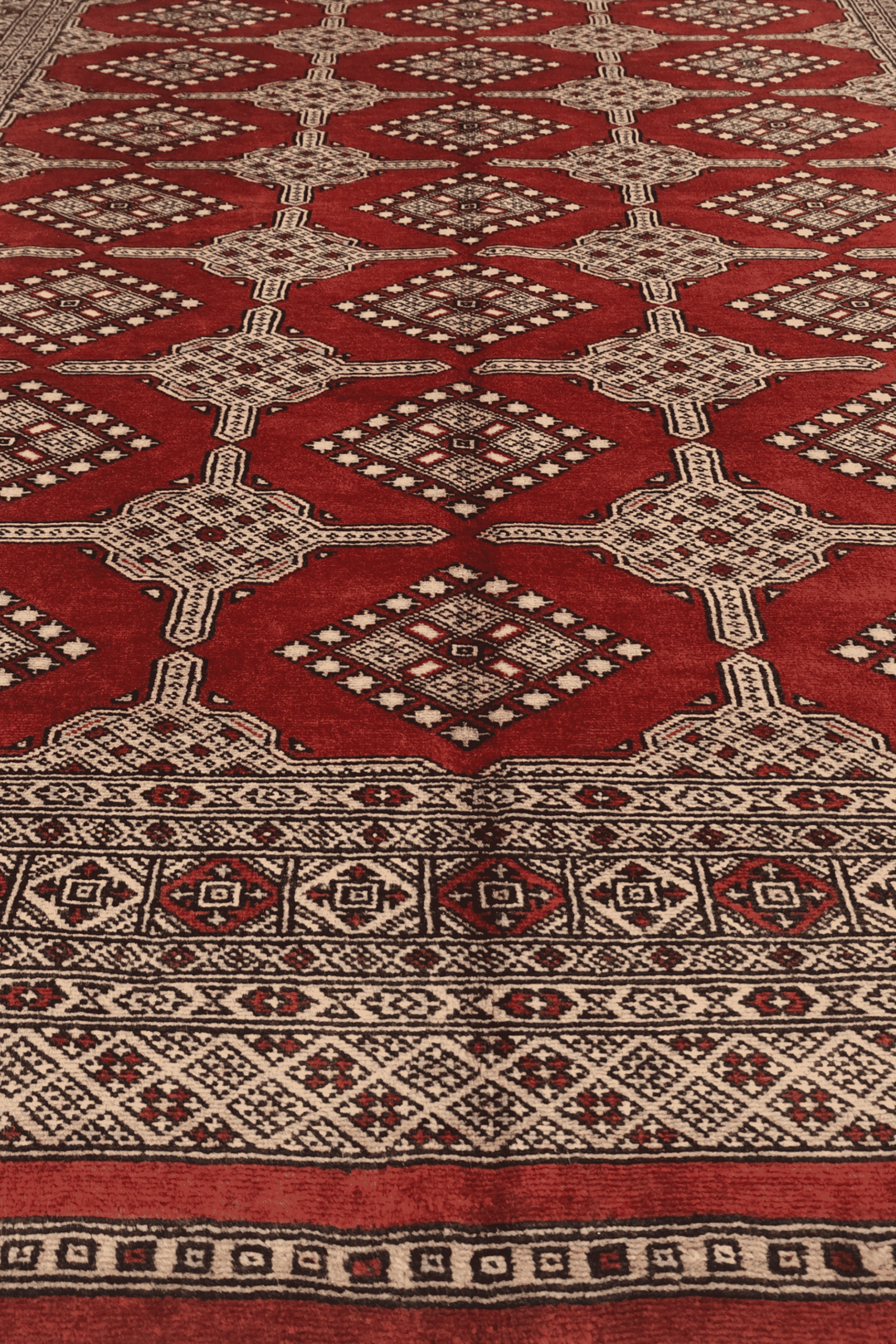 One-of-a-kind brick red and cream Pakistani Bokhara rug