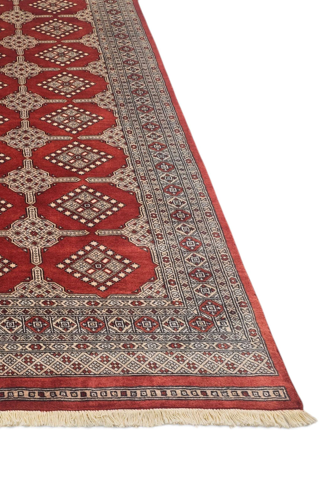 Hand-knotted brick red Bokhara rug with repeating Turkmen güls