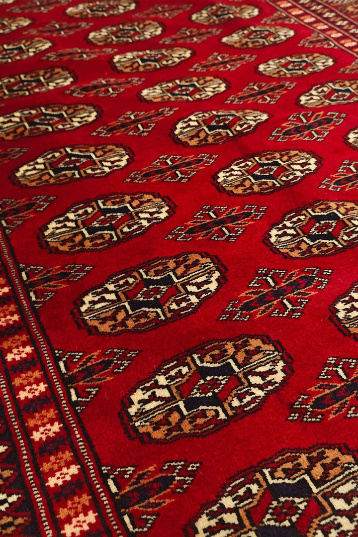 Hand-knotted wool pile of bright red Bokhara rug, 123×172cm