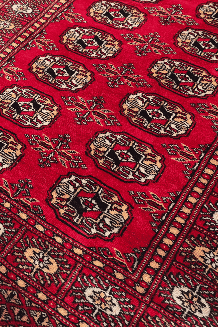 Turkmen gül motifs in bright red and gold on Bokhara runner