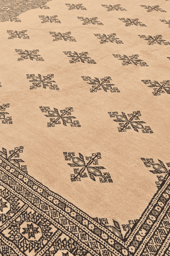 Scattered cross motifs on peach Pakistani Bokhara wool rug