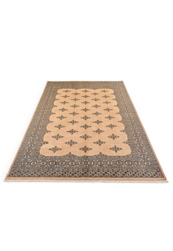 Border detail of peach hand-knotted Bokhara rug, minimal design
