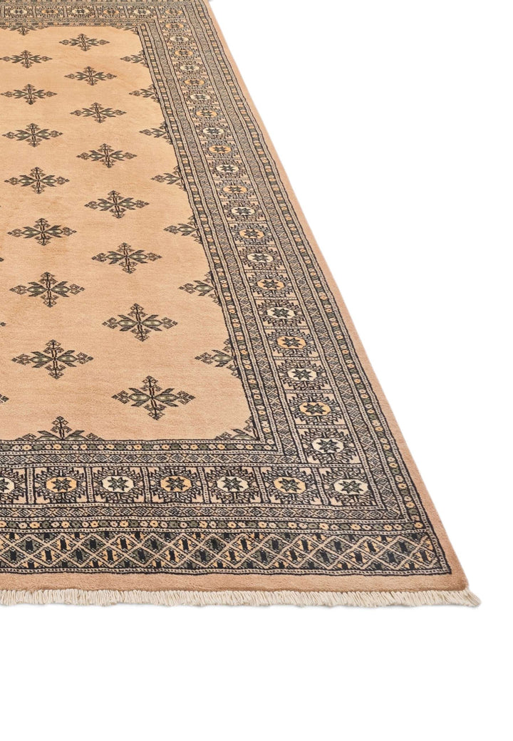 Hand-knotted peach Bokhara rug with sparse cross motifs