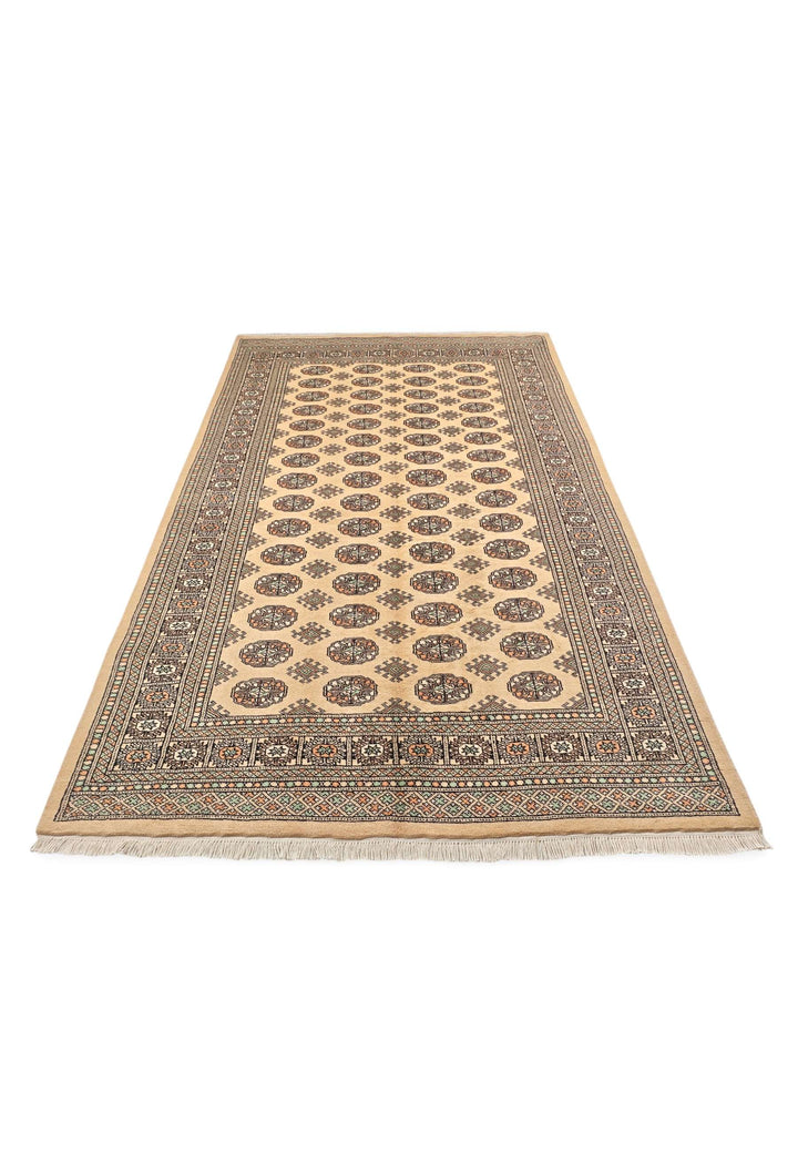 Border detail of warm gold and espresso Bokhara wool rug