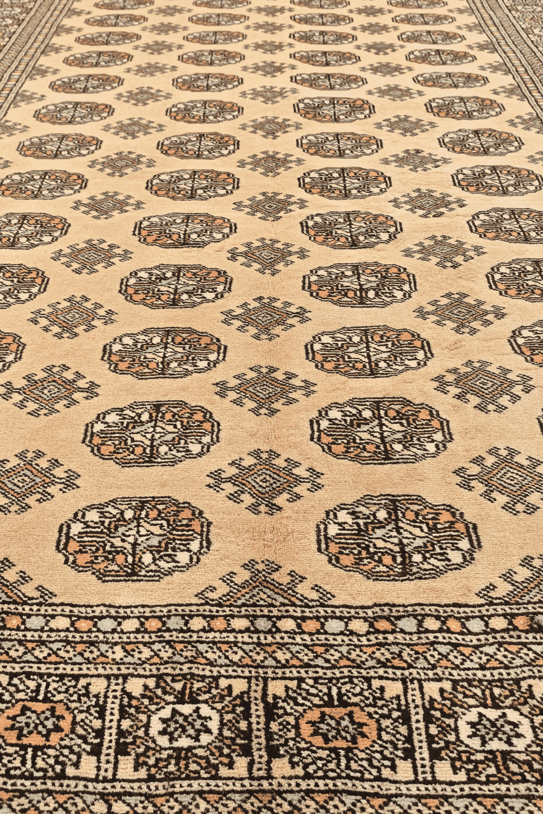 One-of-a-kind warm gold and espresso Pakistani Bokhara rug