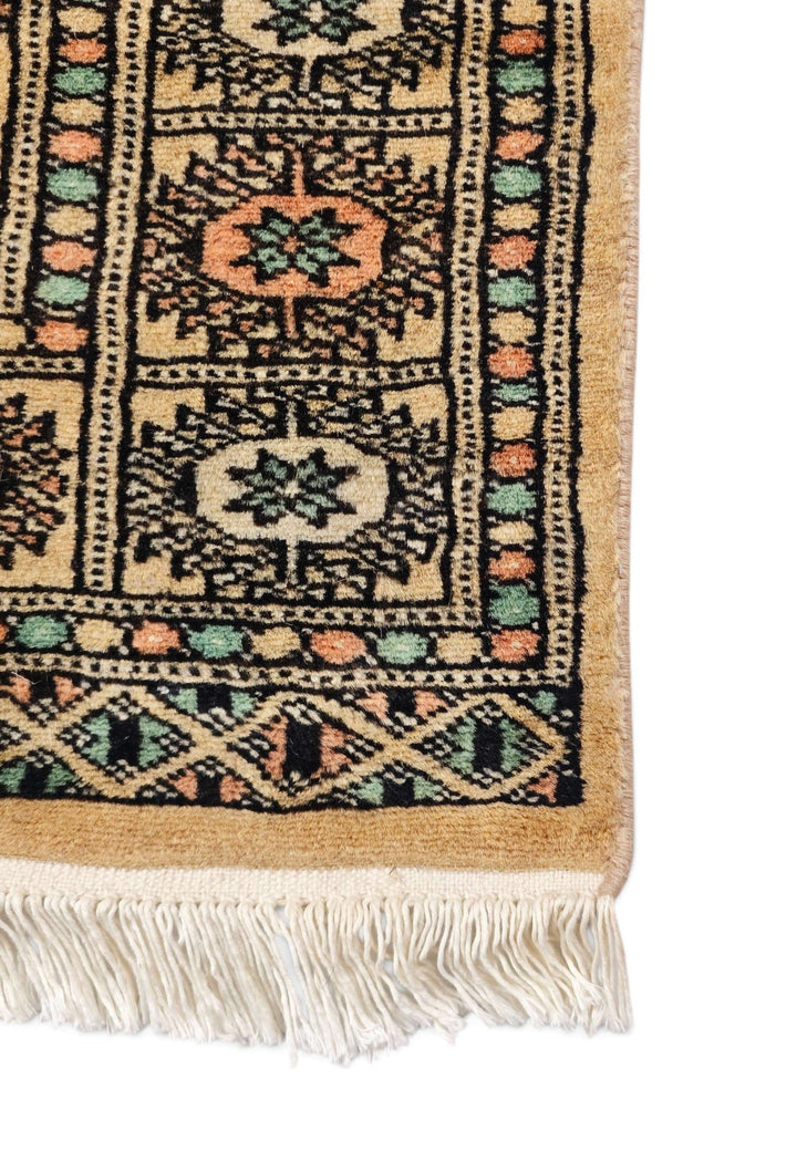 Hand-knotted gold Bokhara rug with peach Turkmen güls