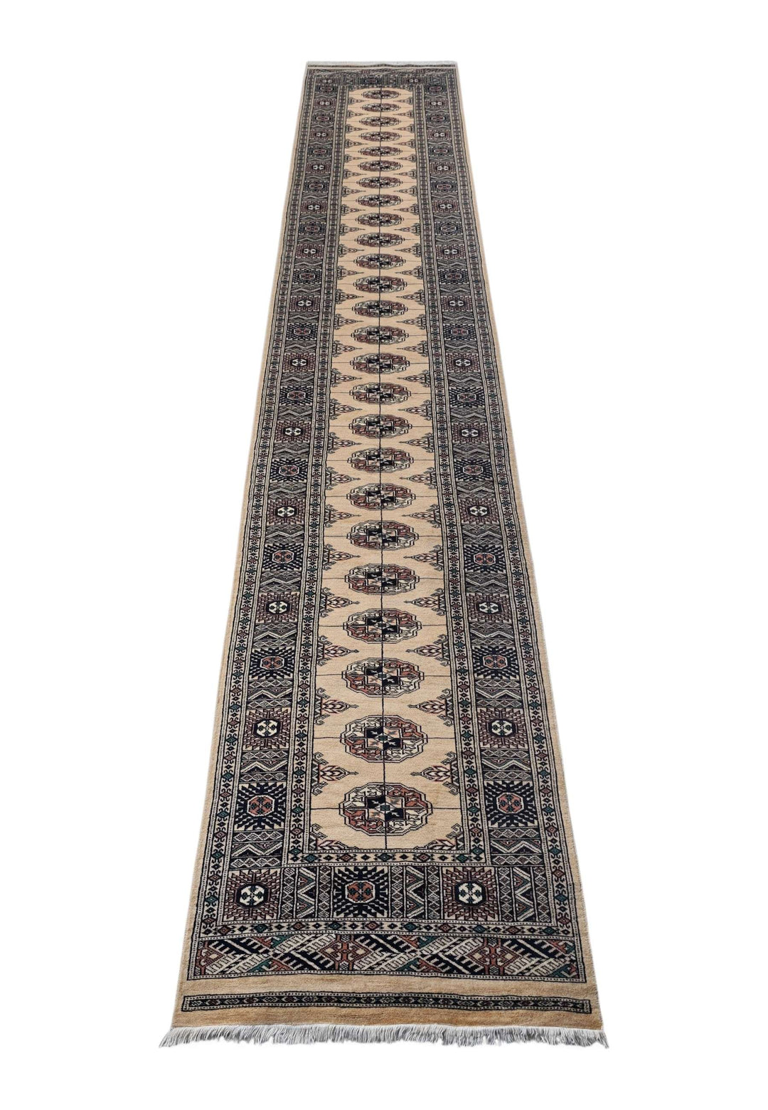 Border detail of camel and navy hand-knotted Bokhara runner