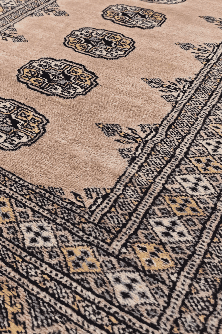 Single column of Turkmen güls in salmon and espresso on Bokhara runner