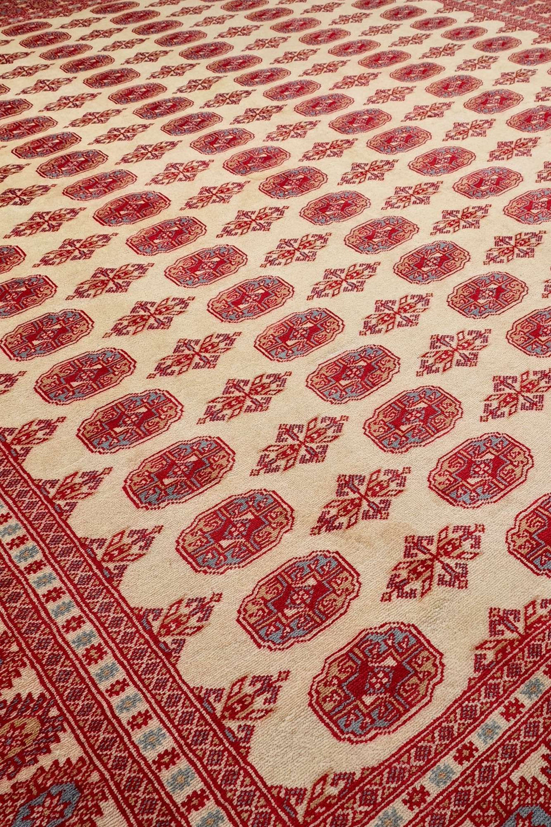 Hand-knotted wool pile of cream and red Bokhara rug, 244×298cm
