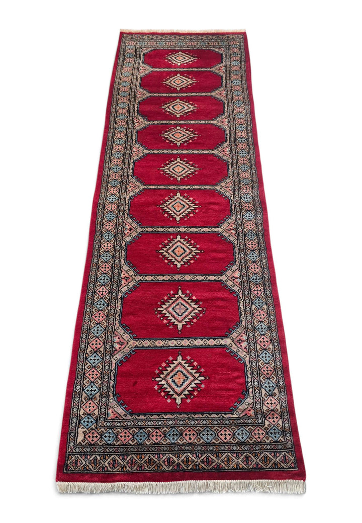 Border detail of crimson and salmon hand-knotted Bokhara runner