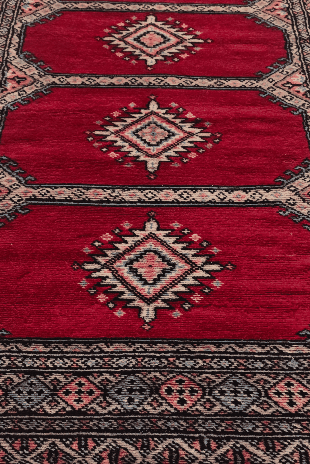 Hand-knotted crimson Bokhara runner with salmon compartments
