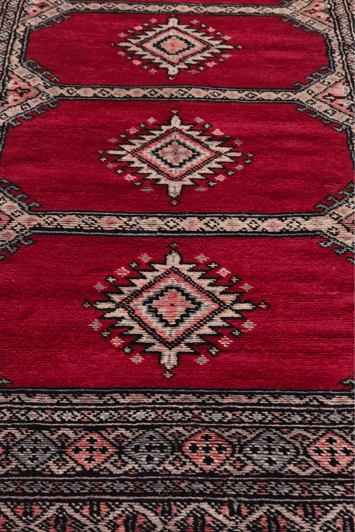 Hand-knotted crimson Bokhara runner with salmon compartments