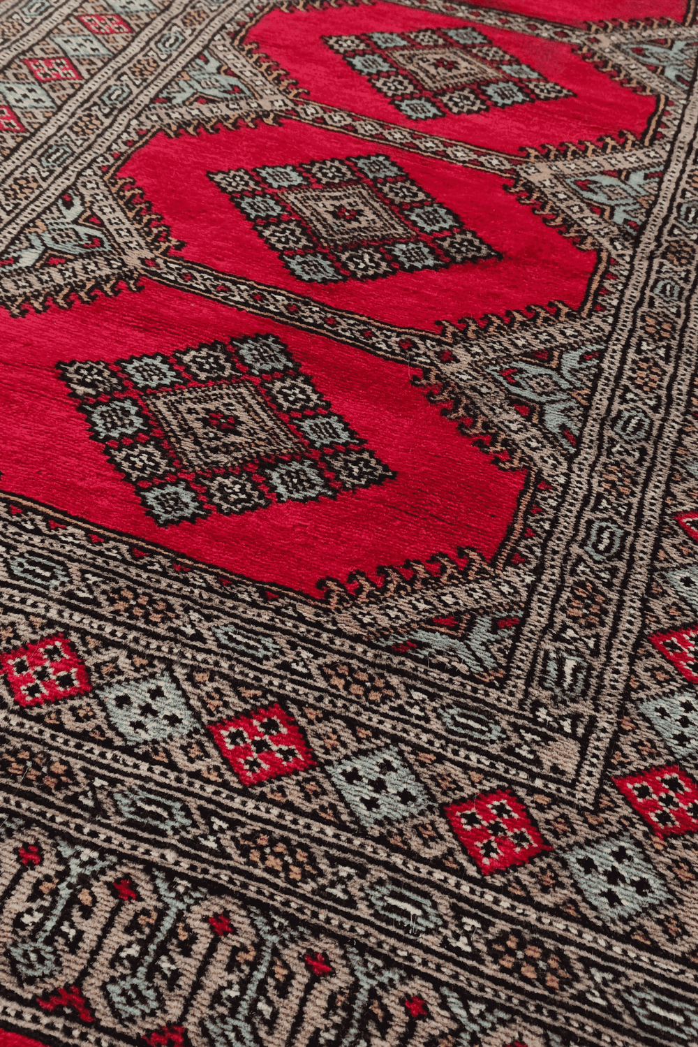 Compartment medallion detail in crimson and taupe on Bokhara runner