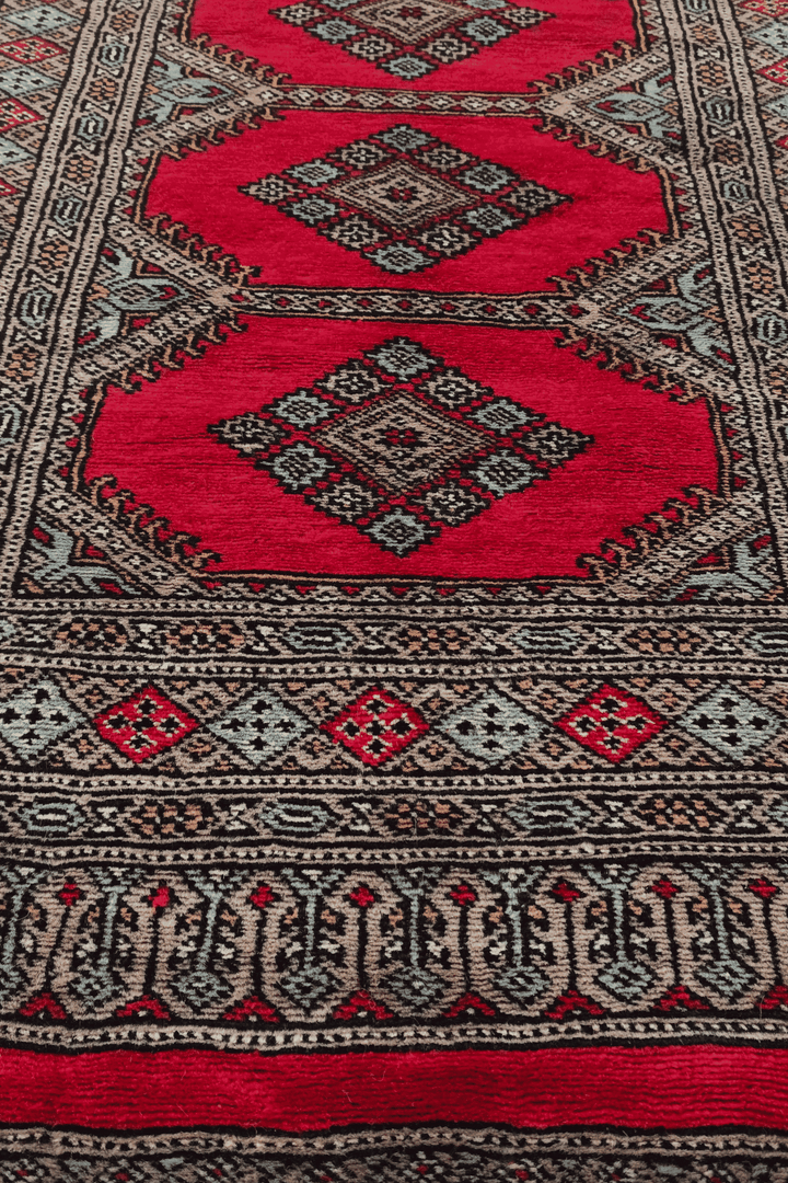 Hand-knotted crimson Bokhara runner with taupe compartments