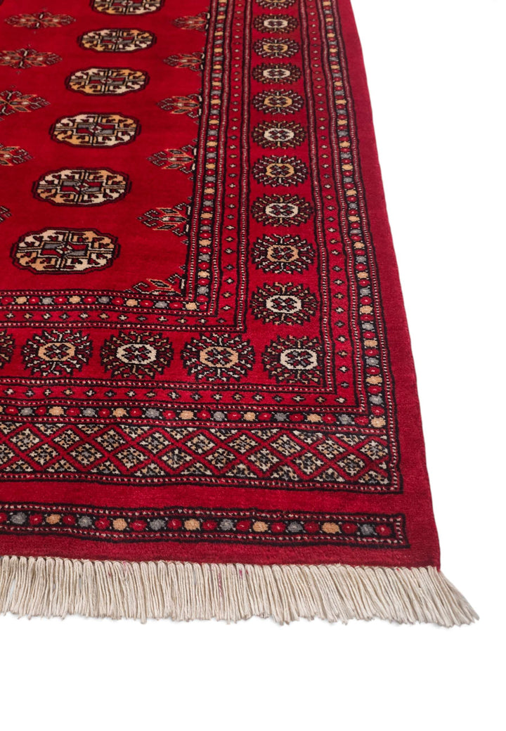 One-of-a-kind crimson and cream Pakistani Bokhara wool rug