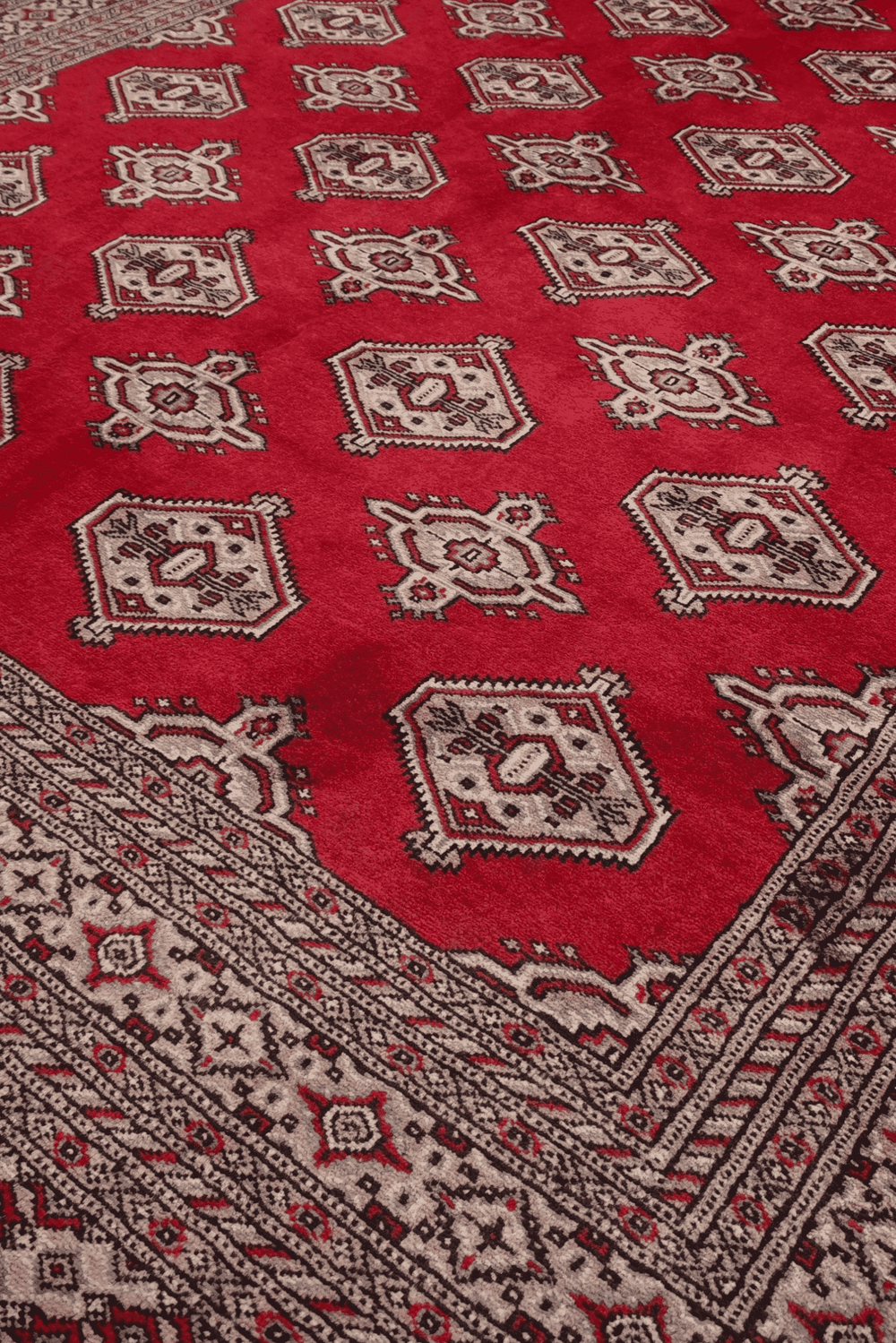 Turkmen gül motifs on deep crimson Pakistani Bokhara rug