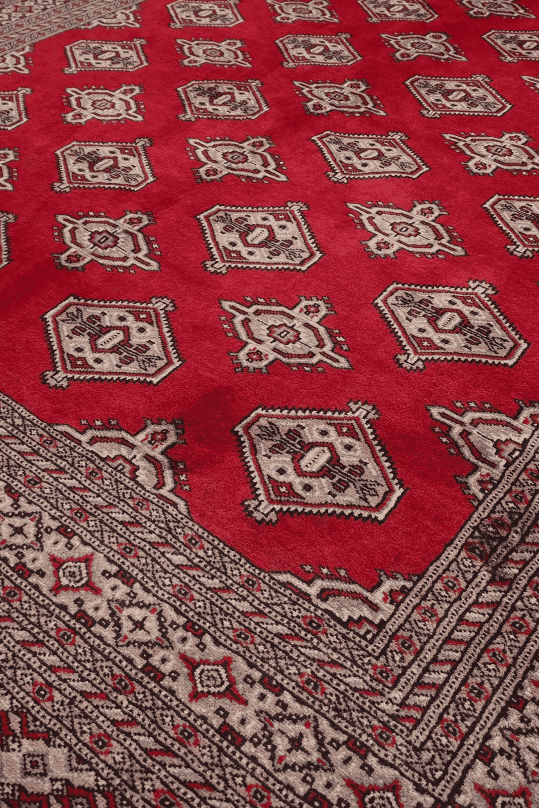 Turkmen gül motifs on deep crimson Pakistani Bokhara rug