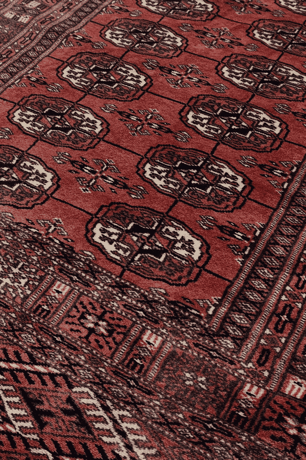 Turkmen gül motifs in brick red and ivory on Afghan runner