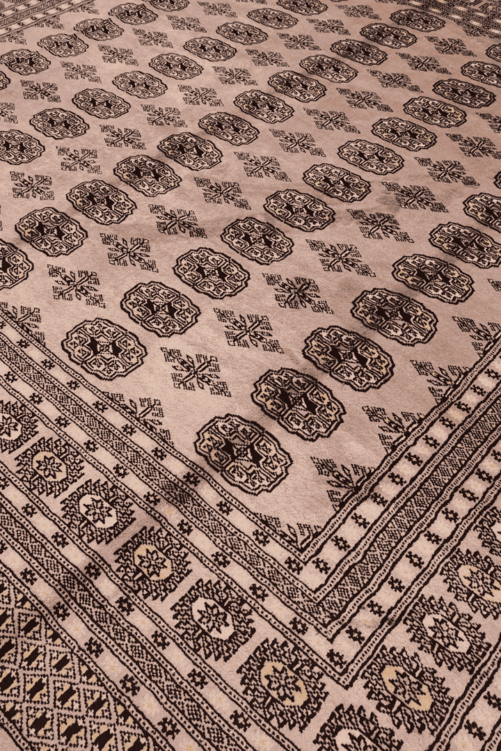 Border detail of dusty taupe hand-knotted square Bokhara rug