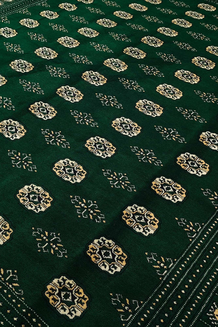 Border detail of emerald green hand-knotted Bokhara rug