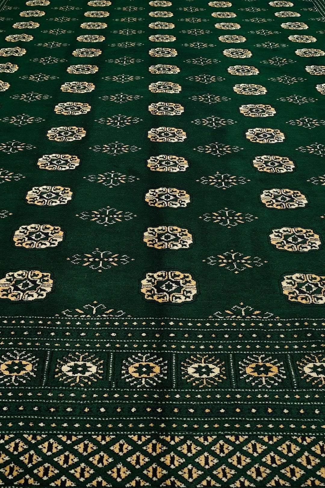 Hand-knotted wool pile of emerald green Bokhara rug, 247×291cm